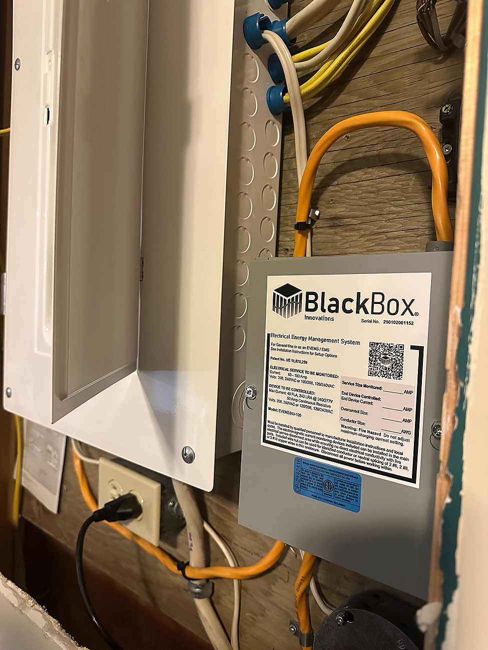Electrician installing a load shedding device on a Calgary electrical panel for improved home safety.