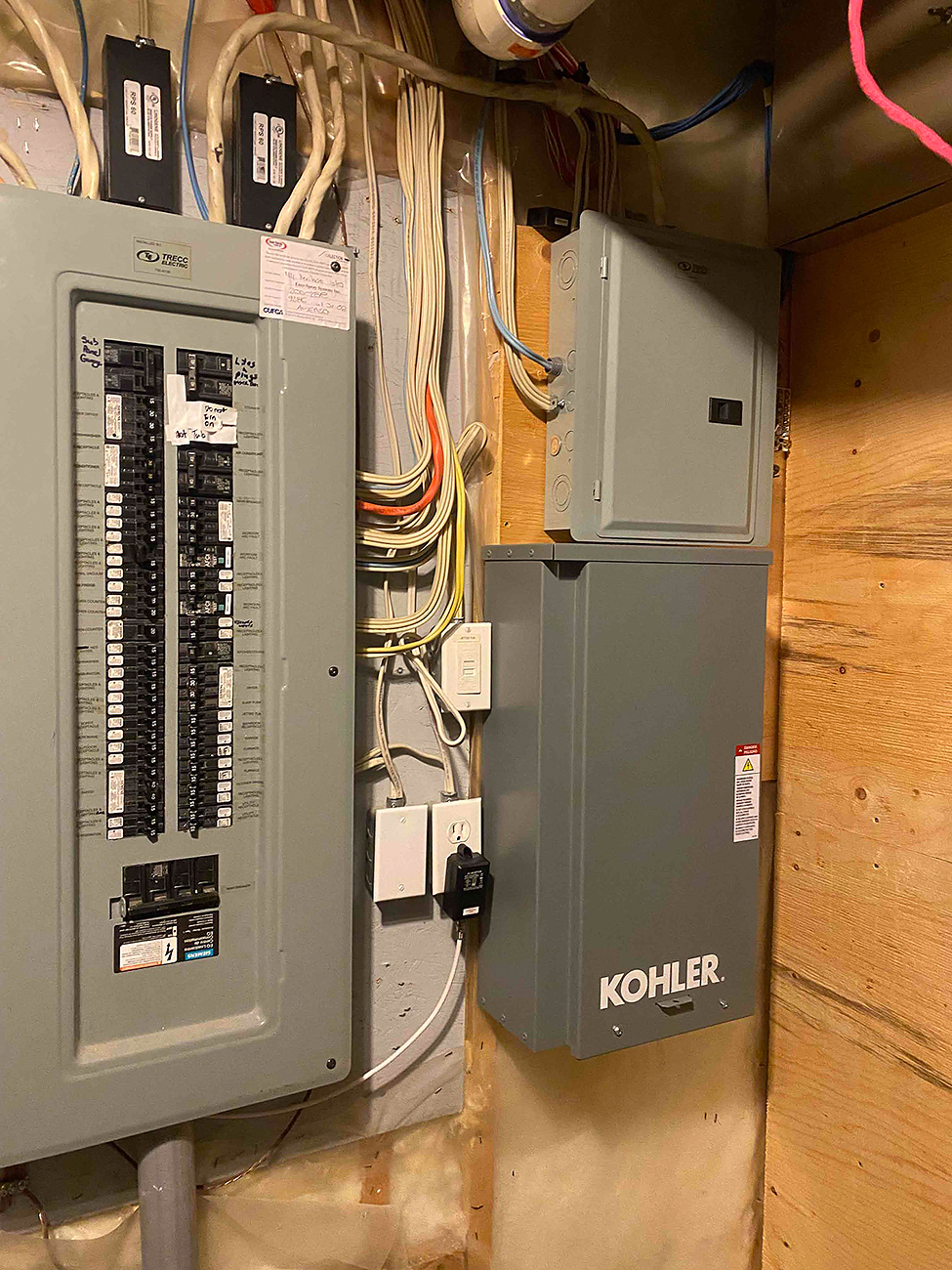 Crew Electrical Services placing a whole home surge protector next to a Calgary electrical panel, short leads and tidy routing