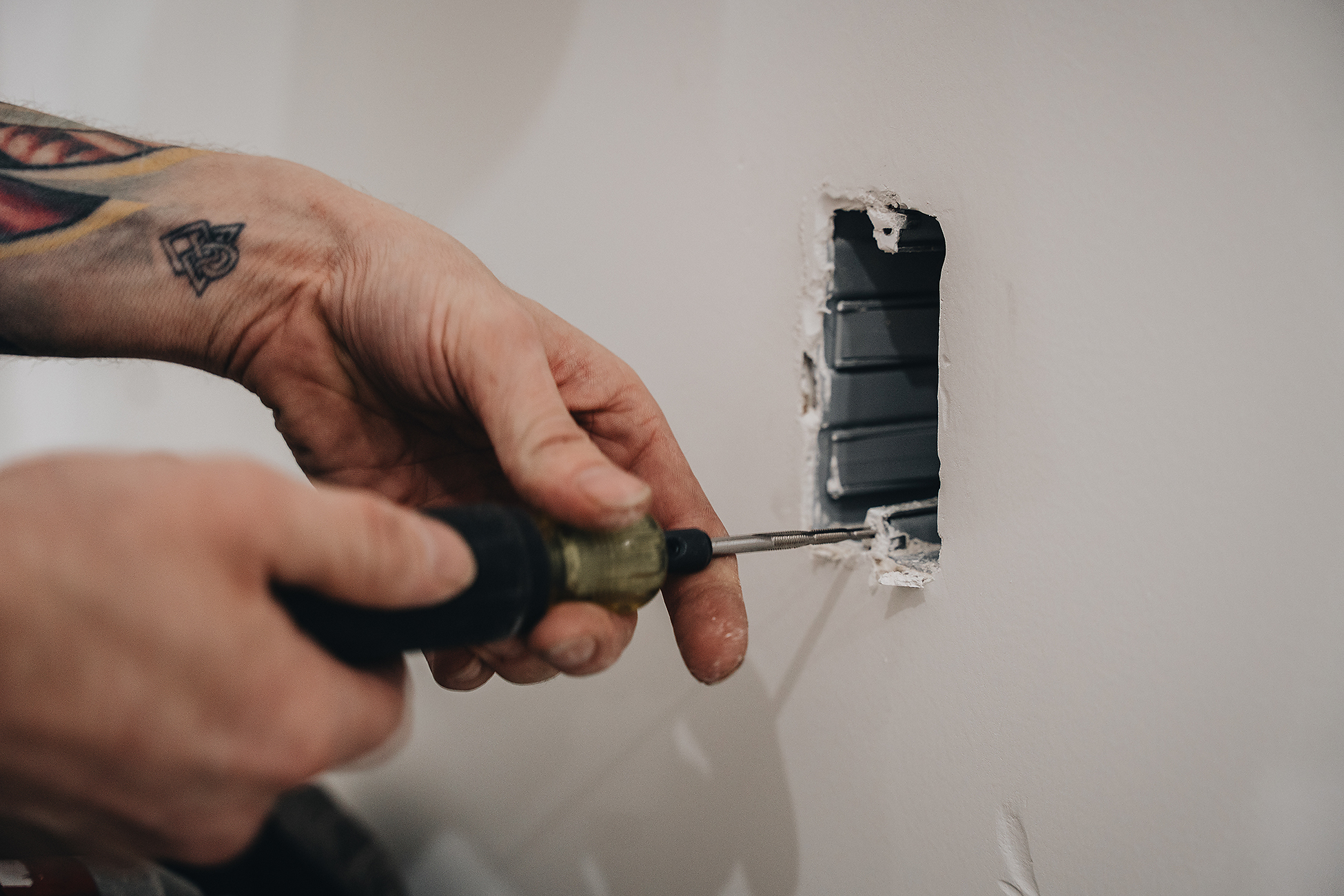 Crew Electrical Services troubleshooting an outlet in a Calgary home