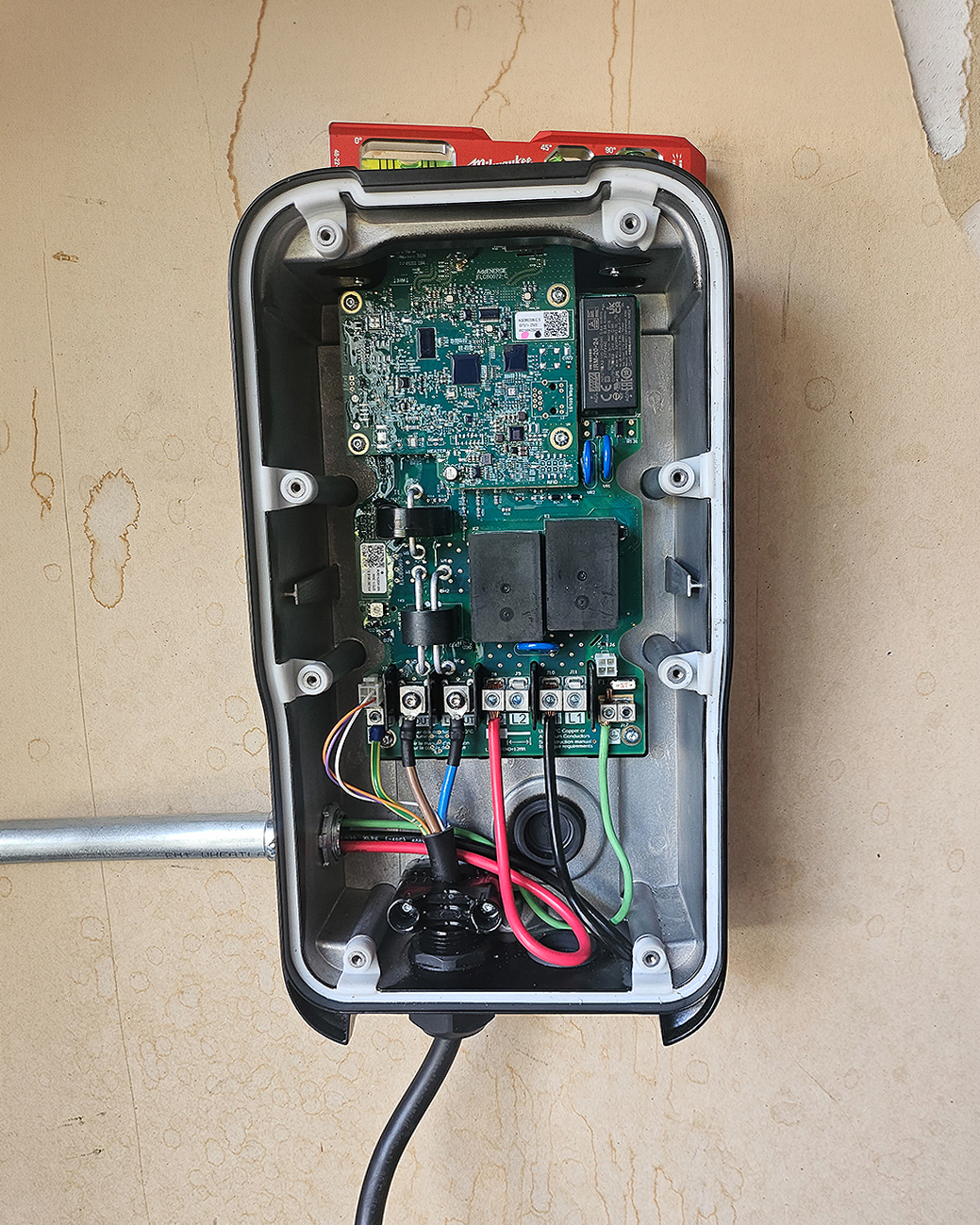 Close-up of a wall-mounted Level 2 EV charger installation