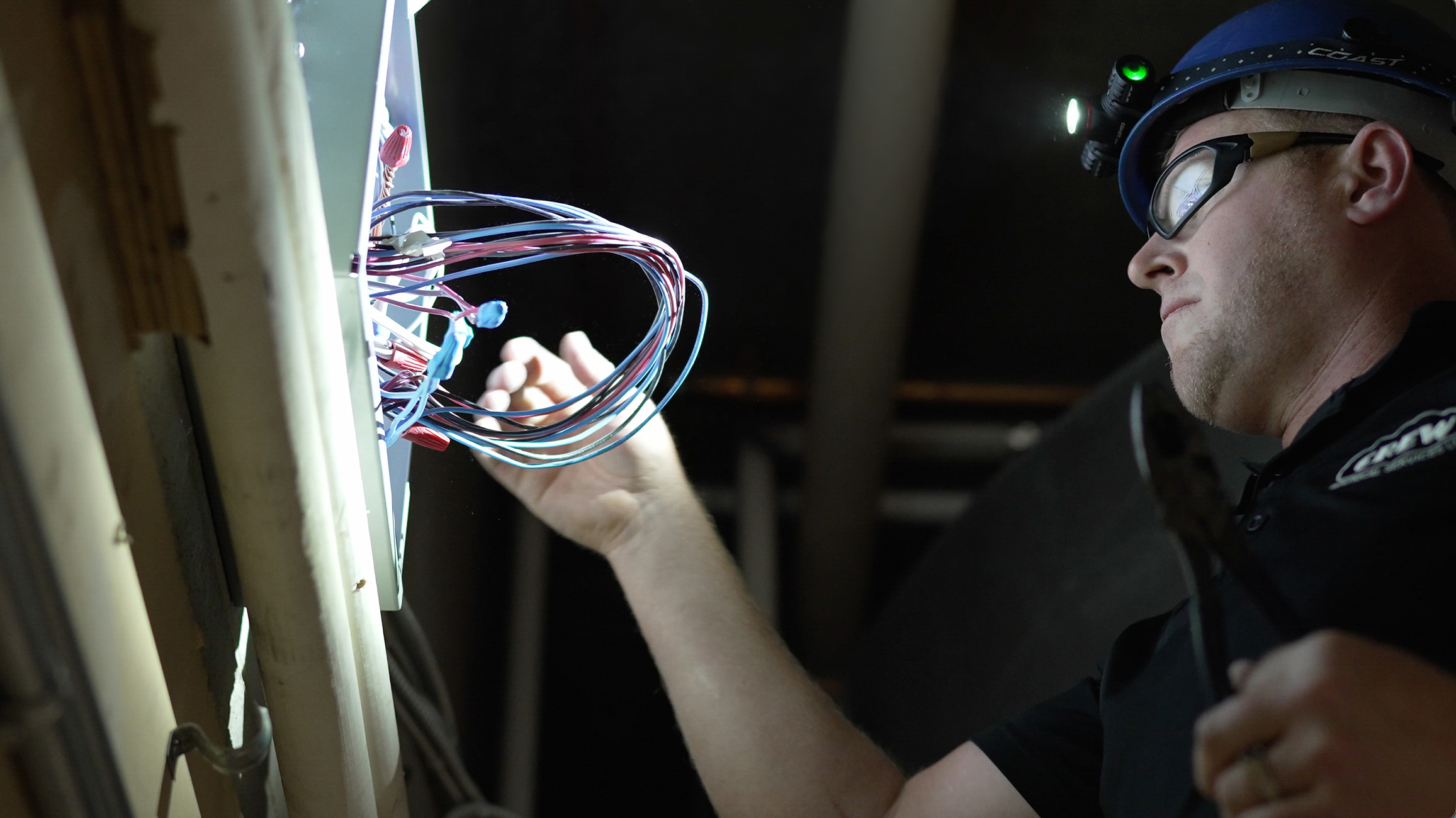 Crew Electrical Services technician working on a commercial electrical panel upgrade