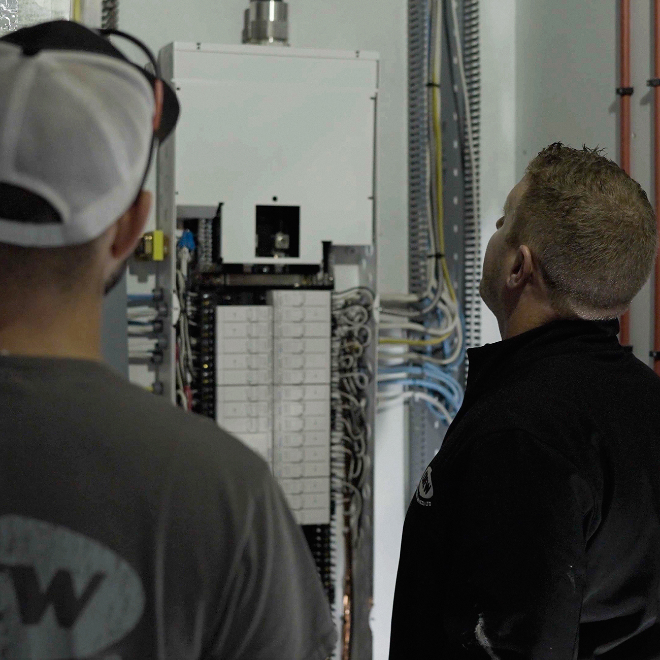 Crew Electrical Services electrician installing an upgraded electrical panel in a Calgary home