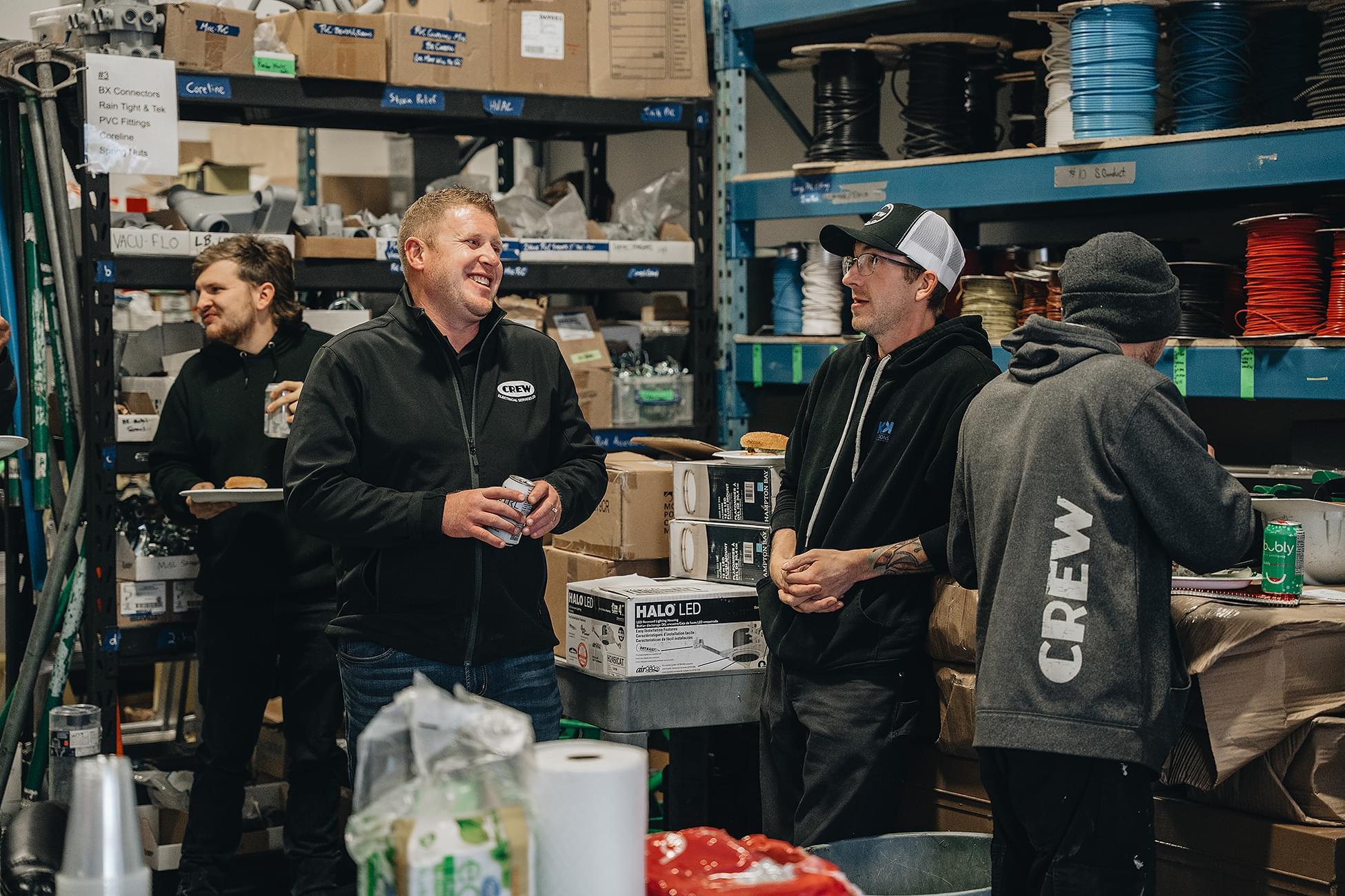 A certified CREW Electrical electrician using a multimeter to troubleshoot an electrical panel in a Calgary home to diagnose a circuit fault.